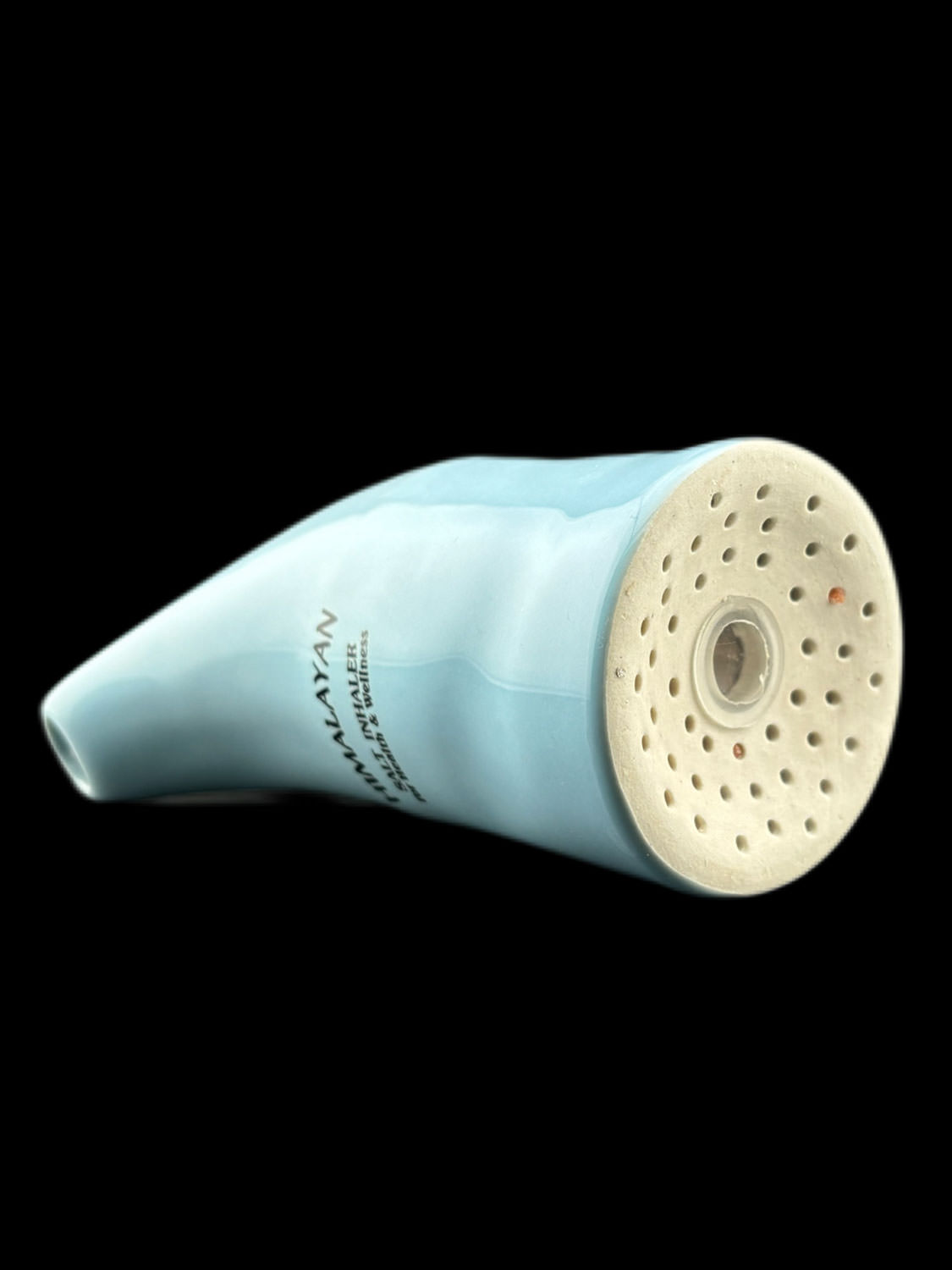 a white ceramic object with holes